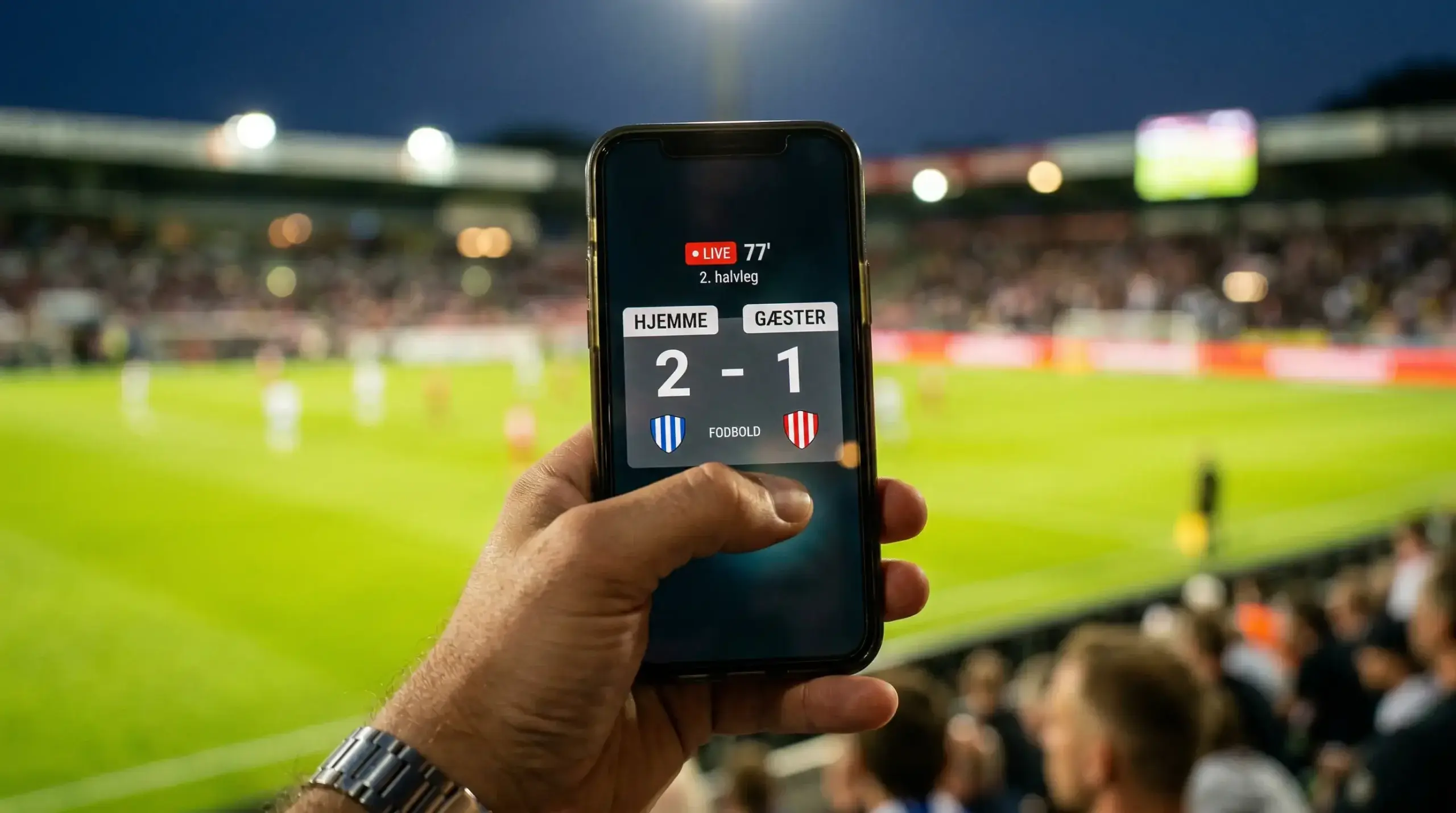Fodboldstadion med live kamp og digitalt display der viser væddemålsmuligheder